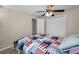 This bedroom features tile floors, a ceiling fan, and closet with bi-fold doors at 13970 Montego Dr, Seminole, FL 33776