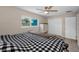 This bedroom features a ceiling fan, view of the pool, and closet with bi-fold doors at 13970 Montego Dr, Seminole, FL 33776