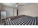 This bedroom features a ceiling fan, tile floors, and closet with bi-fold doors at 13970 Montego Dr, Seminole, FL 33776
