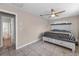 This bedroom features a ceiling fan, tile floors, and en suite bathroom at 13970 Montego Dr, Seminole, FL 33776