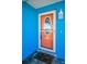 Close-up of the colorful front door with decorative glass and welcome mat at 13970 Montego Dr, Seminole, FL 33776