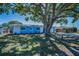 Single-story home featuring a well-maintained lawn and a beautiful mature tree at 13970 Montego Dr, Seminole, FL 33776