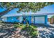 Charming single-story home with a well-maintained lawn and a vibrant blue exterior at 13970 Montego Dr, Seminole, FL 33776