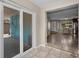 Bright tiled hallway with access to the home's front door and sliding door access to the backyard at 13970 Montego Dr, Seminole, FL 33776