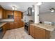 Kitchen includes granite counters, stainless steel appliances, wooden cabinets, and a central island with range at 13970 Montego Dr, Seminole, FL 33776