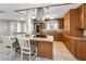 Kitchen includes granite counters, stainless steel appliances, a central island, and custom cabinetry at 13970 Montego Dr, Seminole, FL 33776