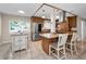 Updated kitchen boasts granite countertops, stainless steel appliances, wooden cabinetry, and a convenient breakfast bar at 13970 Montego Dr, Seminole, FL 33776