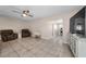 Spacious living room showcasing an open floor plan and a ceiling fan at 13970 Montego Dr, Seminole, FL 33776