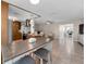 Open-concept living room features tile flooring, a ceiling fan, and leads into the kitchen area, bathed in natural light at 13970 Montego Dr, Seminole, FL 33776