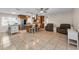 Open-concept layout with kitchen island, seating and tile floors at 13970 Montego Dr, Seminole, FL 33776