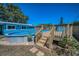 Charming deck leading to the above-ground pool, with steps and railings at 13970 Montego Dr, Seminole, FL 33776