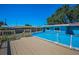 Well-kept backyard with deck leading to above-ground pool at 13970 Montego Dr, Seminole, FL 33776