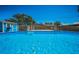 Sparkling pool featuring ladder and wood deck nestled in tranquil backyard at 13970 Montego Dr, Seminole, FL 33776