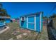 Backyard shed painted a nice blue color, with window and flower box at 13970 Montego Dr, Seminole, FL 33776