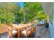 Open patio area with outdoor wooden furniture and a lush green backyard at 1431 Kings Hwy, Clearwater, FL 33755