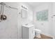 Contemporary bathroom featuring marble-look shower and vanity with modern fixtures, providing a sleek and clean design at 1431 Kings Hwy, Clearwater, FL 33755