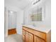 Bright bathroom featuring a modern vanity with drawers, tile flooring, and an overhead vanity light at 1431 Kings Hwy, Clearwater, FL 33755