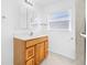Bathroom with a vanity, cabinet, and mirror, plus tiled floors and plenty of light at 1431 Kings Hwy, Clearwater, FL 33755
