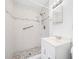 Modern bathroom featuring a stylish vanity with a marble tile shower, providing a luxurious and functional design at 1431 Kings Hwy, Clearwater, FL 33755