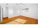 Light and airy bedroom with hardwood floors, ceiling fan, and ample natural light from the window at 1431 Kings Hwy, Clearwater, FL 33755
