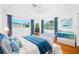 Bright bedroom featuring hardwood floors, large windows, and nautical-themed decorations and furnishings at 1431 Kings Hwy, Clearwater, FL 33755