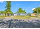 Charming single-story home features a light blue exterior, well-maintained lawn, and attached one car garage at 1431 Kings Hwy, Clearwater, FL 33755