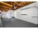 Open garage featuring painted walls, with an access door, and concrete floors at 1431 Kings Hwy, Clearwater, FL 33755