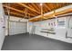Spacious garage with exposed beams, painted floors and walls, and large door at 1431 Kings Hwy, Clearwater, FL 33755