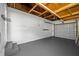 Garage showcasing an automatic door system, painted walls, and concrete floors at 1431 Kings Hwy, Clearwater, FL 33755