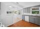 Bright kitchen view featuring gray cabinets and sight lines to living room at 1431 Kings Hwy, Clearwater, FL 33755