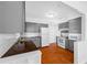Well-lit kitchen featuring gray cabinets, white appliances, and tile flooring at 1431 Kings Hwy, Clearwater, FL 33755