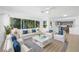 Stylish living room featuring white furniture with blue pillows and modern decor at 1431 Kings Hwy, Clearwater, FL 33755