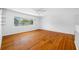 Bright living room featuring hardwood floors, a large window, and neutral walls at 1431 Kings Hwy, Clearwater, FL 33755