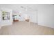 Open concept living room with tile flooring leads to the kitchen in this bright, airy home at 1431 Kings Hwy, Clearwater, FL 33755
