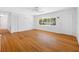 Bright living room featuring hardwood floors, a large window, and neutral walls at 1431 Kings Hwy, Clearwater, FL 33755