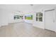 Bright living room with tile floors, neutral walls, and multiple windows offering natural light at 1431 Kings Hwy, Clearwater, FL 33755