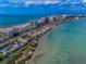 An aerial view displaying a coastal condo community with beaches and bay access at 1451 Gulf Blvd # 207, Clearwater Beach, FL 33767