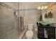 Modern bathroom featuring a glass shower, toilet, and unique glass sink with black cabinet at 1451 Gulf Blvd # 207, Clearwater Beach, FL 33767
