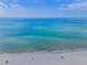 A beautiful aqua ocean view on a pristine white sandy beach with gentle waves at 1451 Gulf Blvd # 207, Clearwater Beach, FL 33767