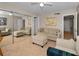 Spacious living room with mirrored wall, a sofa, an ottoman and a work desk at 1451 Gulf Blvd # 207, Clearwater Beach, FL 33767