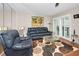Comfortable living room featuring a leather sofa and an area rug at 1451 Gulf Blvd # 207, Clearwater Beach, FL 33767