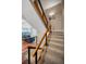 Carpeted staircase with wooden railing leading to the living area with cozy blue furniture at 1451 Gulf Blvd # 207, Clearwater Beach, FL 33767