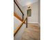 Carpeted staircase with wooden handrails featuring a decorative wall mirror at 1451 Gulf Blvd # 207, Clearwater Beach, FL 33767