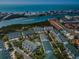 Breathtaking aerial view of waterfront condos, with a pool and lush landscaping near the Intracoastal Waterway and beach at 14692 Seminole Trl, Seminole, FL 33776
