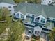 Aerial view of a charming townhome featuring a green roof, dormer windows, and well-kept landscaping at 14692 Seminole Trl, Seminole, FL 33776