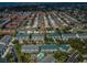 Aerial view showcasing a residential area with condominium complexes, mature trees, and a swimming pool at 14692 Seminole Trl, Seminole, FL 33776