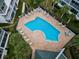 An aerial view of the community pool with surrounding lounge chairs and landscaping, providing a luxurious and relaxing outdoor space at 14692 Seminole Trl, Seminole, FL 33776