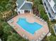 An aerial view of the community pool and cabana surrounded by lush palm trees, offering a resort-style living experience at 14692 Seminole Trl, Seminole, FL 33776