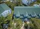 Aerial view of townhomes featuring green roofs, manicured landscaping, and convenient parking at 14692 Seminole Trl, Seminole, FL 33776