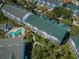 Aerial view of residences, pool, and lush landscaping within the community at 14692 Seminole Trl, Seminole, FL 33776